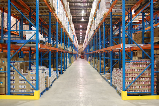 High-density drive-in pallet racking system in a warehouse, designed for deep lane storage and space optimization.