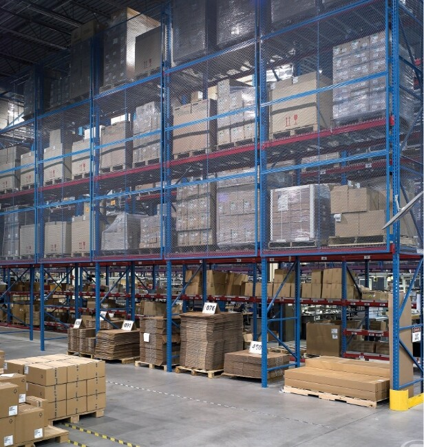 Warehouse pallet racking secured with wire mesh partitions to protect stored goods